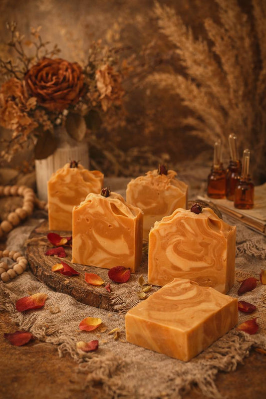 LUMÉA Sandalwood artisan soap bar – cold process soap slices with a creamy swirl, styled with rose petals, eucalyptus and warm fairy lights.