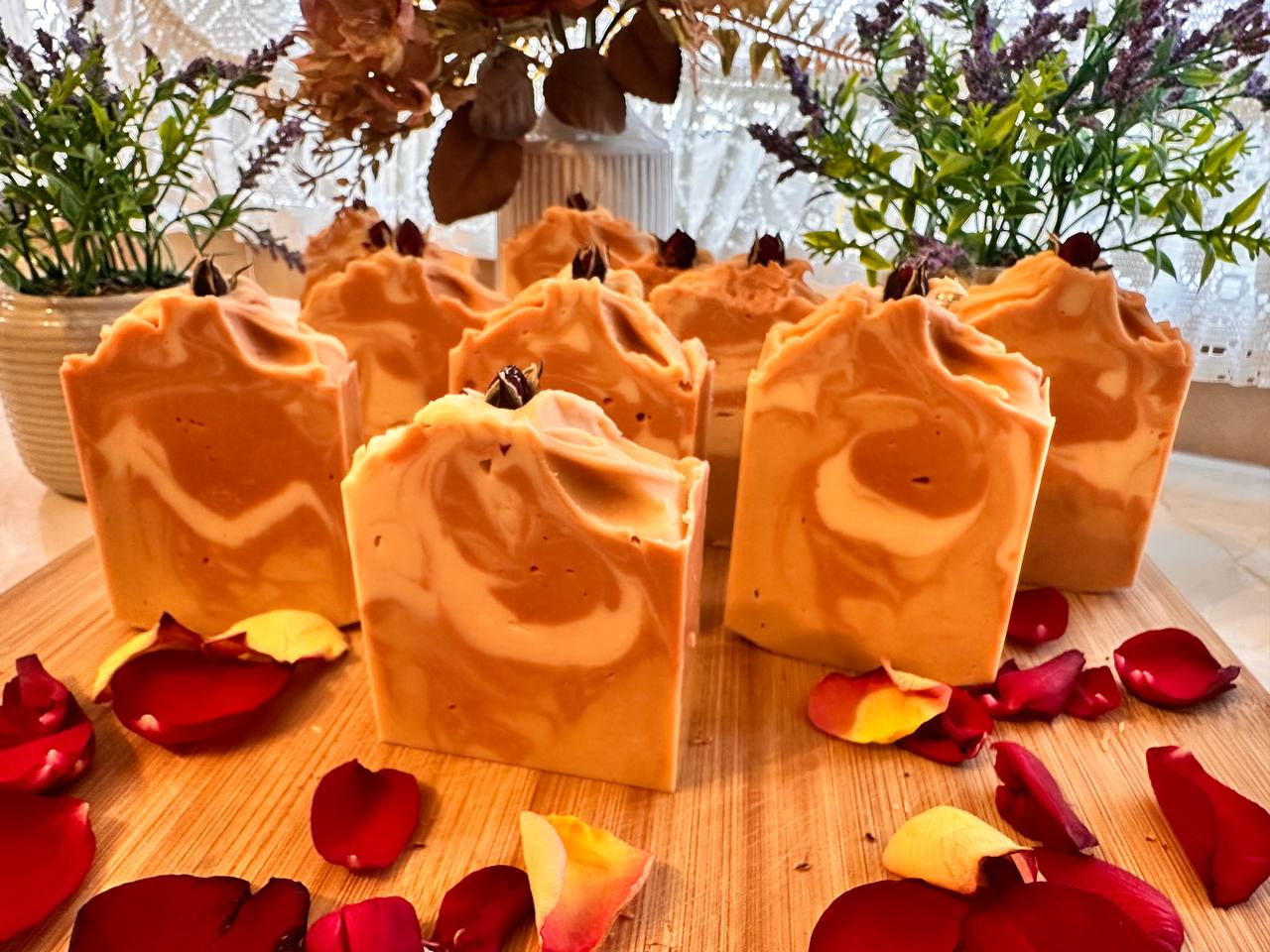 Hand-cut LUMÉA Sandalwood soap bars on a wooden board with rose petals in natural daylight – artisan cold process soap, approx. 130g (125–135g).
