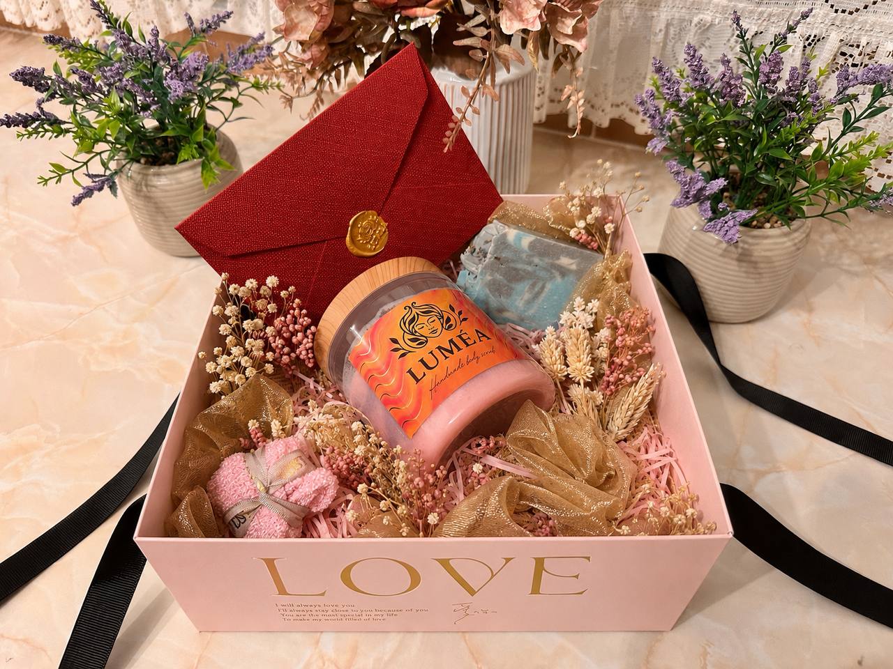 LUMÉA London skincare gift set for her with handmade pink body scrub, artisan soap, dried flowers and elegant gift presentation in a soft pink gift box