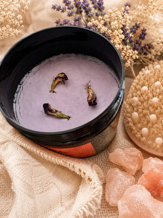 LUMÉA natural handmade body scrub with exfoliating nature oils texture, dried flowers, Himalayan salt crystals and spa body brush in boho setting